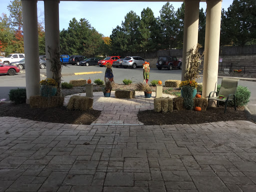 A welcoming outdoor seating area with planters, surrounded by a beautiful landscape, perfect for enjoying the autumn weather.