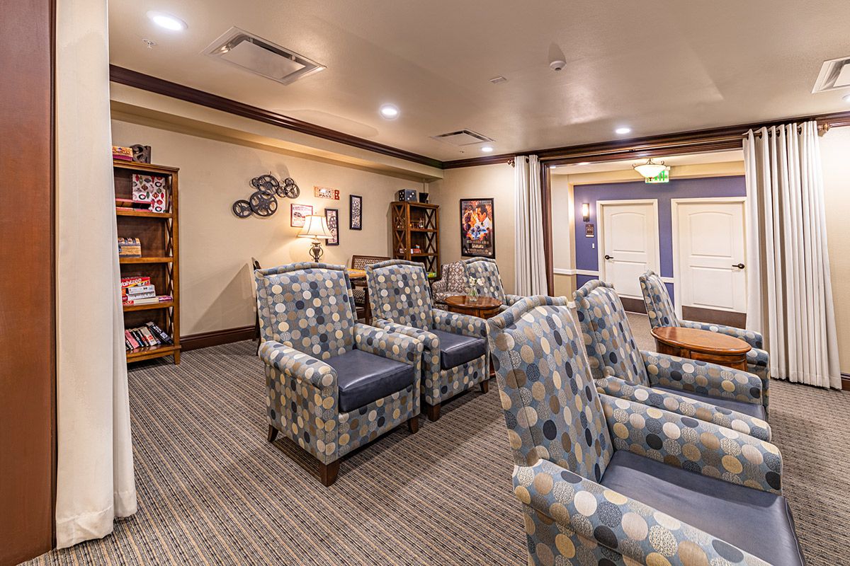 A cozy lounge area with patterned armchairs and warm decor.
