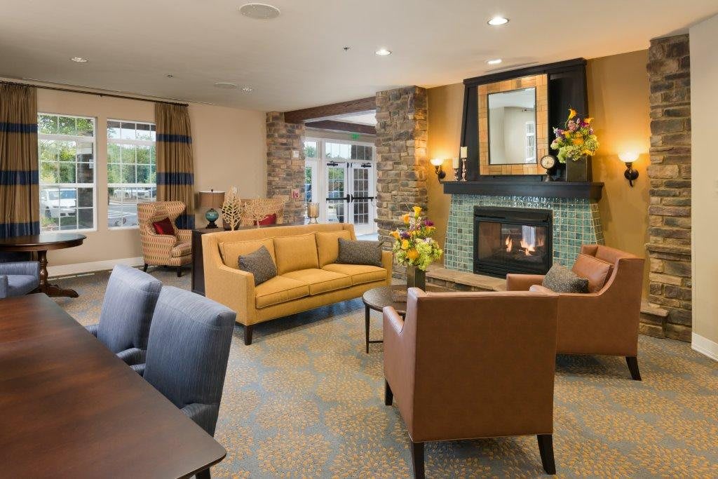 A cozy and modern living room with a fireplace and comfortable seating.
