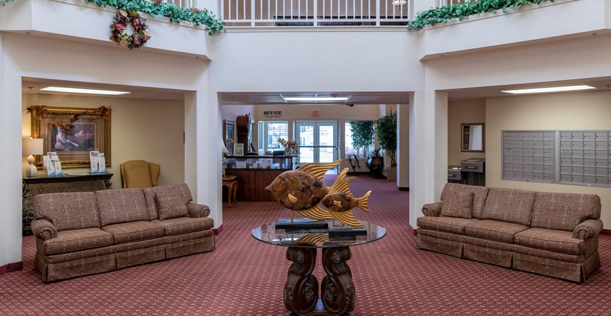 A spacious lobby interior with comfortable sofas and decorative elements.