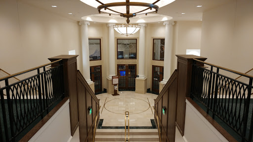 An elegant lobby showcasing classic architectural elements and a grand chandelier.