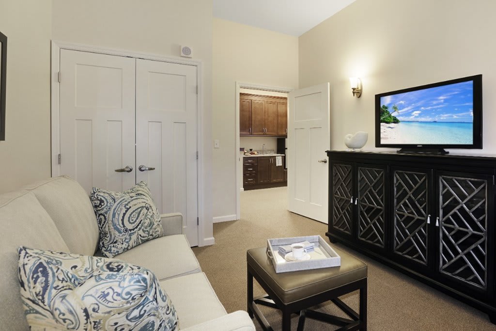A cozy living room with a TV and comfortable seating.