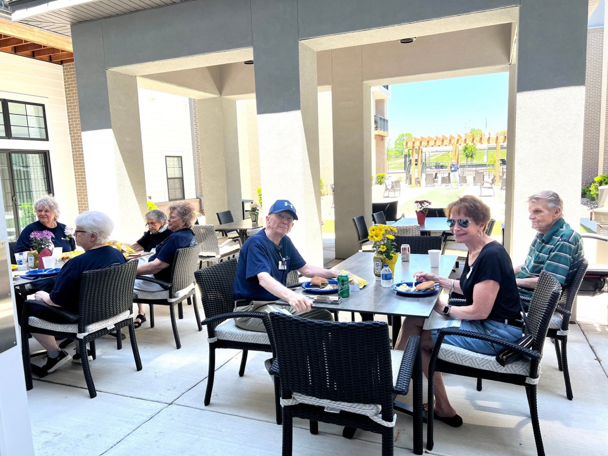 People enjoying a meal on an outdoor patio at a restaurant.