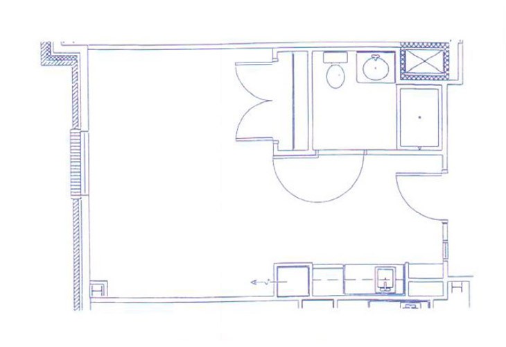A blueprint of a room layout featuring a bathroom and kitchen area.