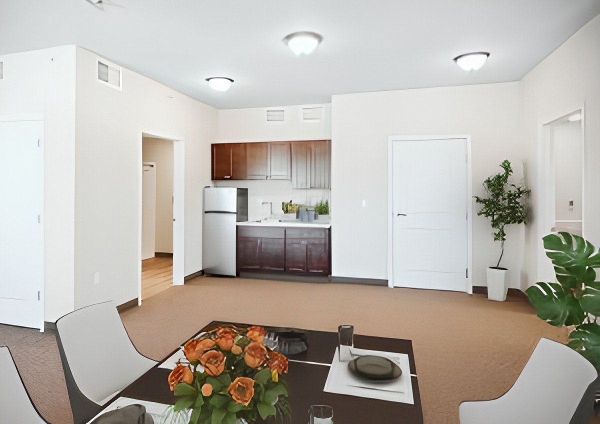 A modern apartment interior featuring a small kitchen and dining area with minimalist decor.