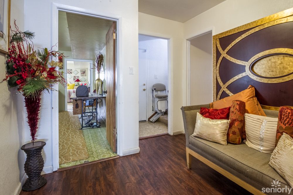 A cozy living room with modern decor and wood flooring.