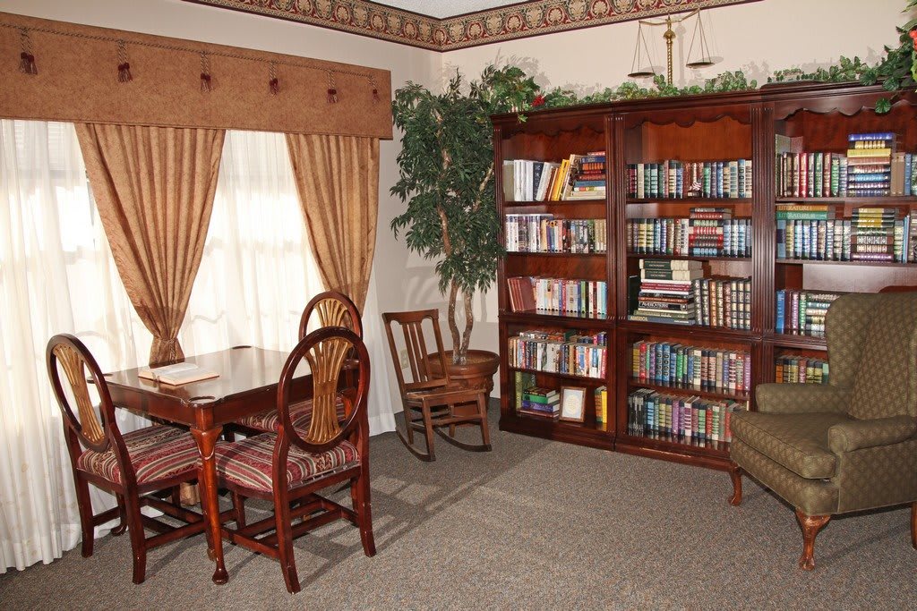 Cozy reading room with a wooden bookshelf and seating area.