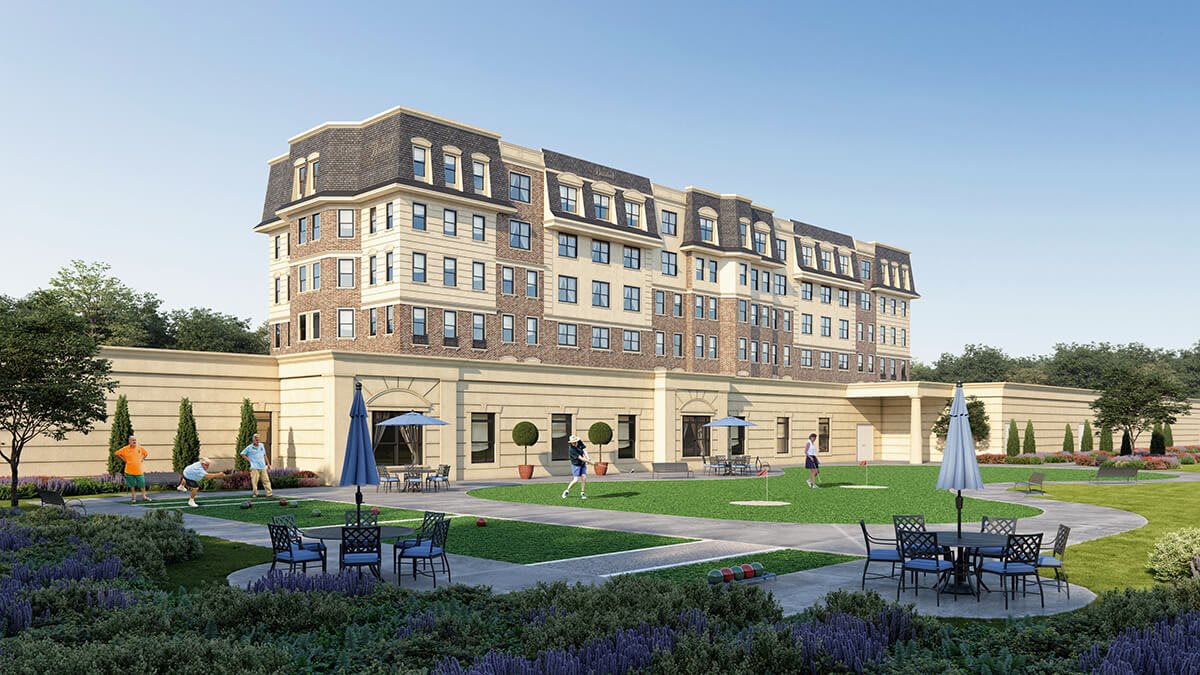 A sunny day view of a large, elegant residential building with well-maintained lawns and outdoor seating.