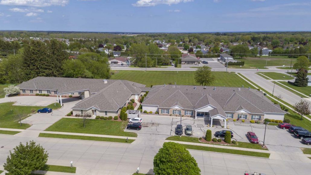 Aerial view of a suburban residential area with houses and a parking lot.