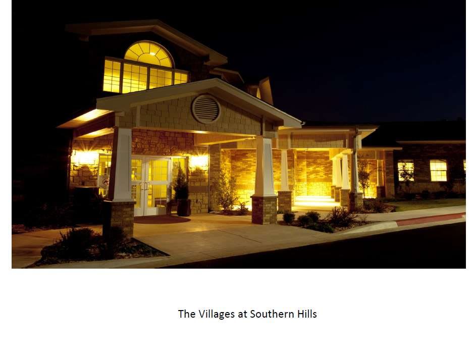 The entrance of The Villages at Southern Hills illuminated at night.