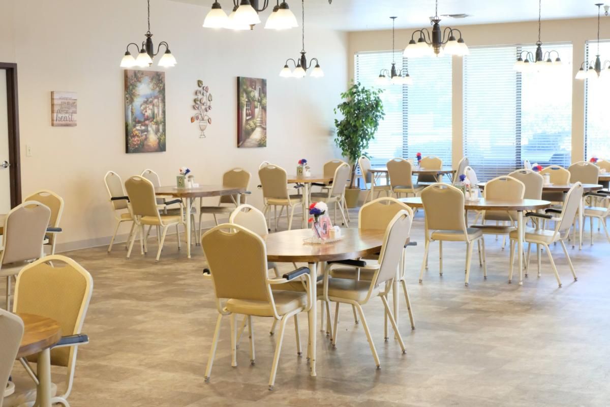A bright and spacious dining area with neatly arranged tables and chairs.