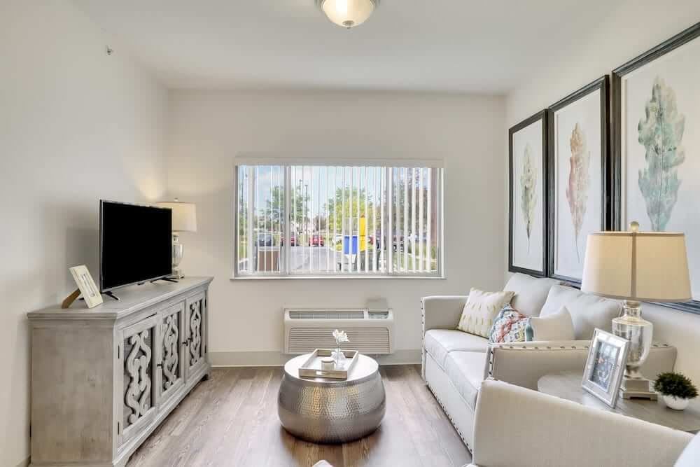 A modern living room with sleek furniture and bright natural lighting.