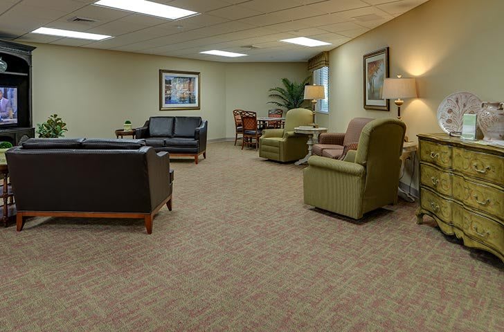 A spacious waiting room with comfortable seating and warm lighting.