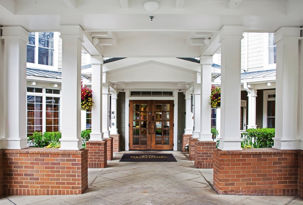 Grand entrance with columns and brickwork.