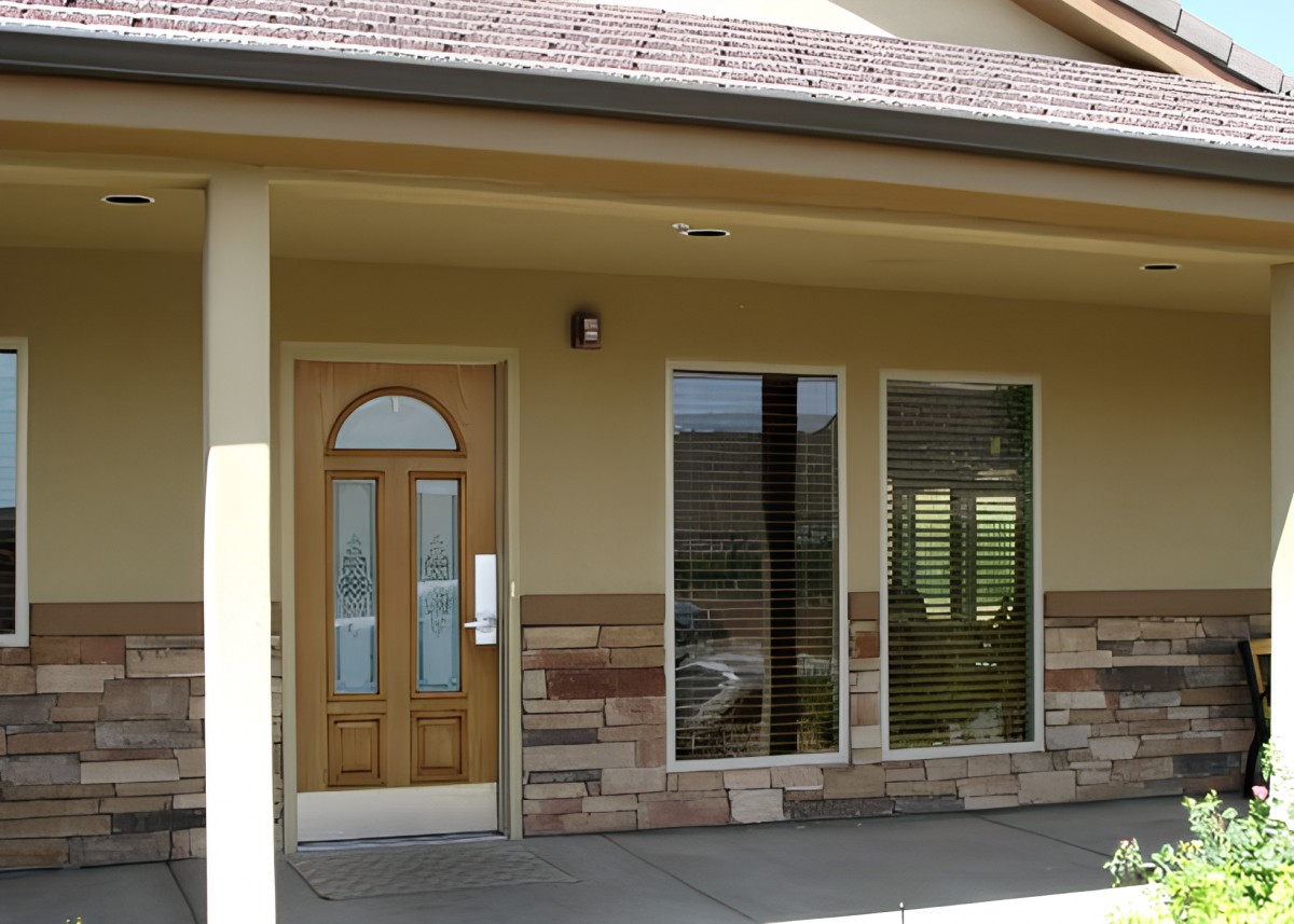 A small storefront with a wooden door and two large windows.