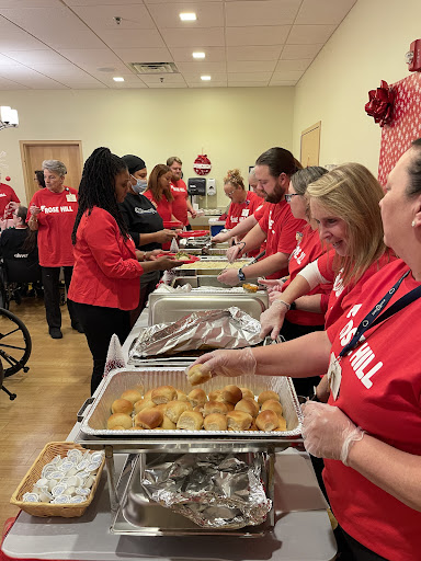 Volunteers serving food at a community event, spreading joy and warmth during the holiday season.