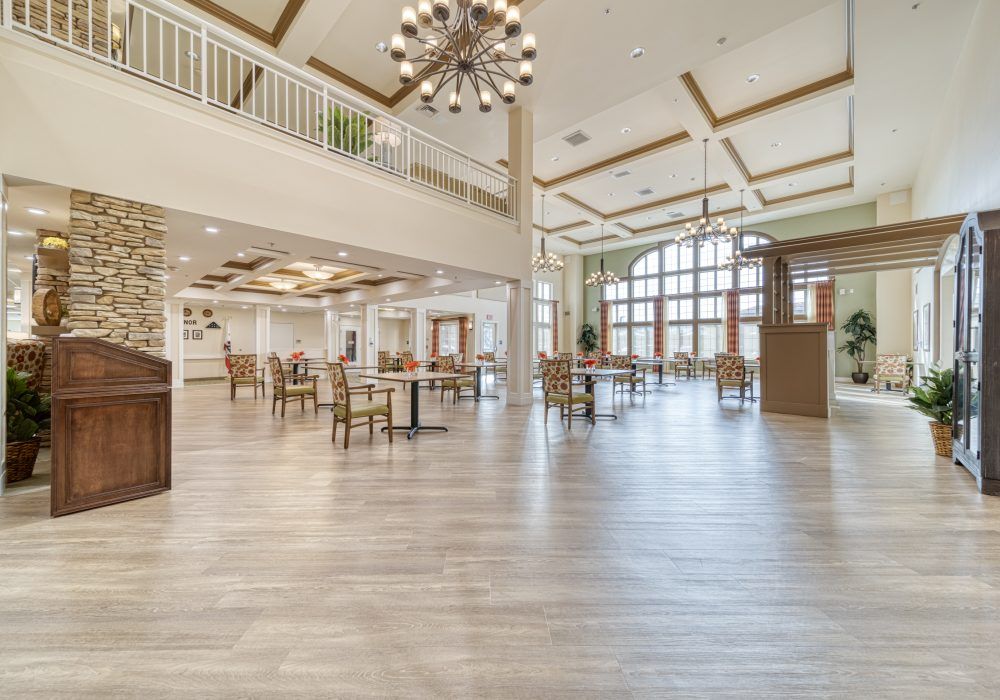 A spacious and modern dining area with abundant natural light and elegant chandeliers.