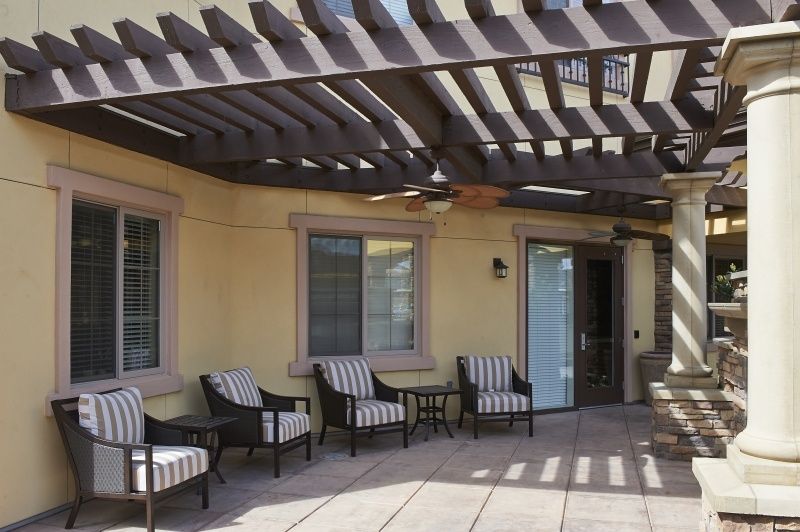 A relaxing outdoor patio area with a pergola and comfortable seating.