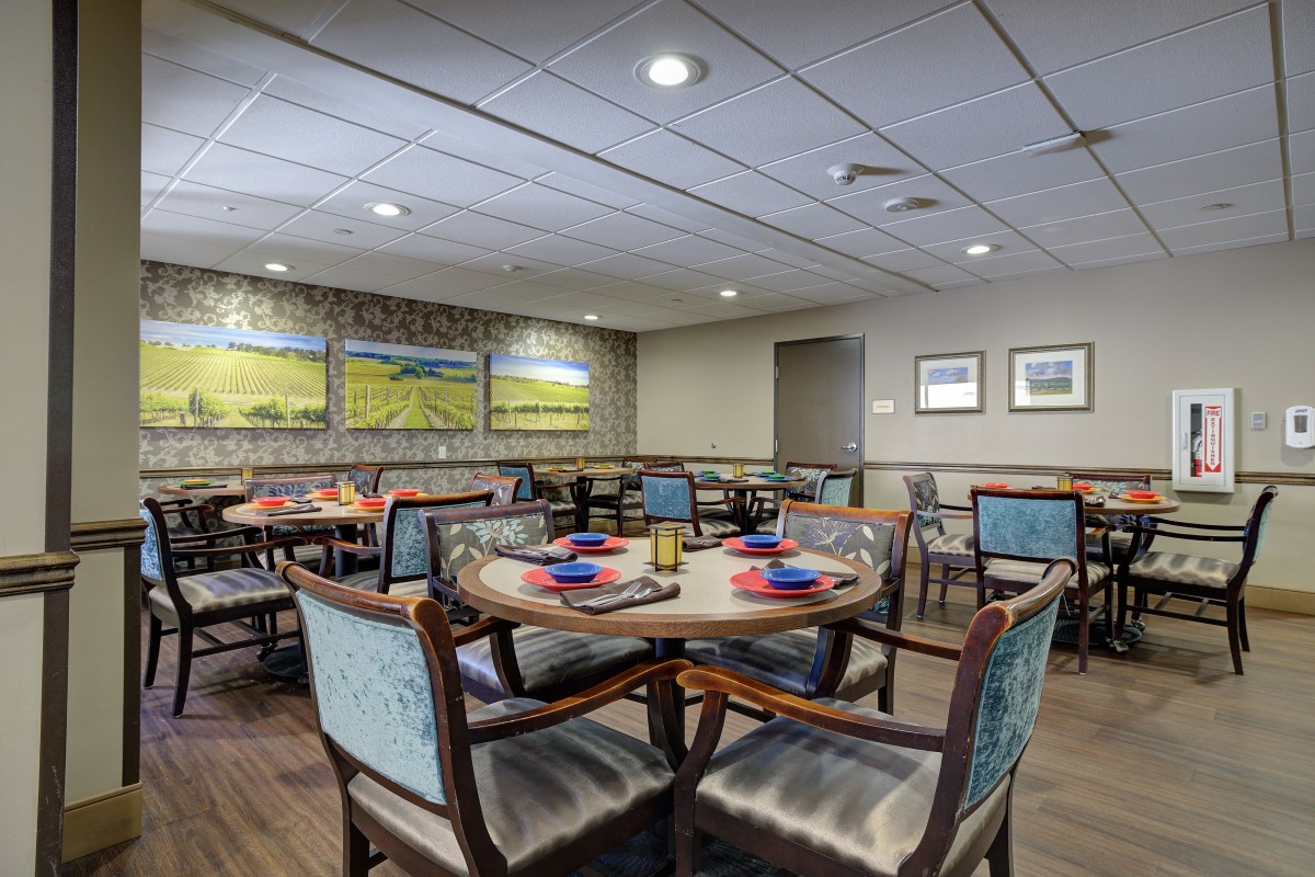 A cozy dining area with neatly arranged tables and chairs, showcasing elegant decor and place settings.