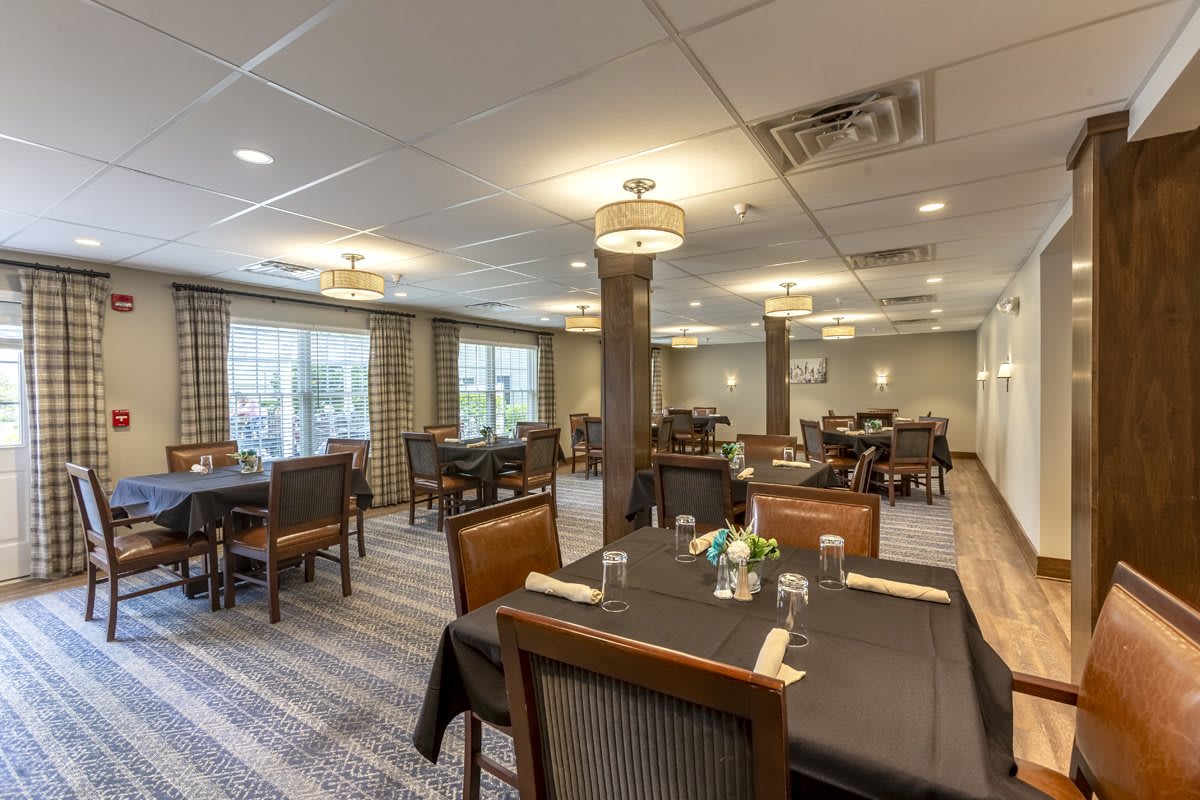 A well-arranged dining area with neatly set tables and soft lighting.