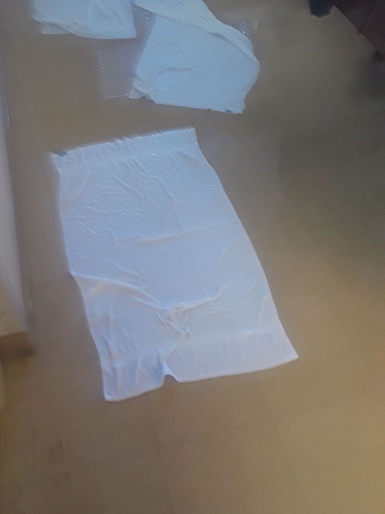 Flooded indoor area with floating sheet of paper.