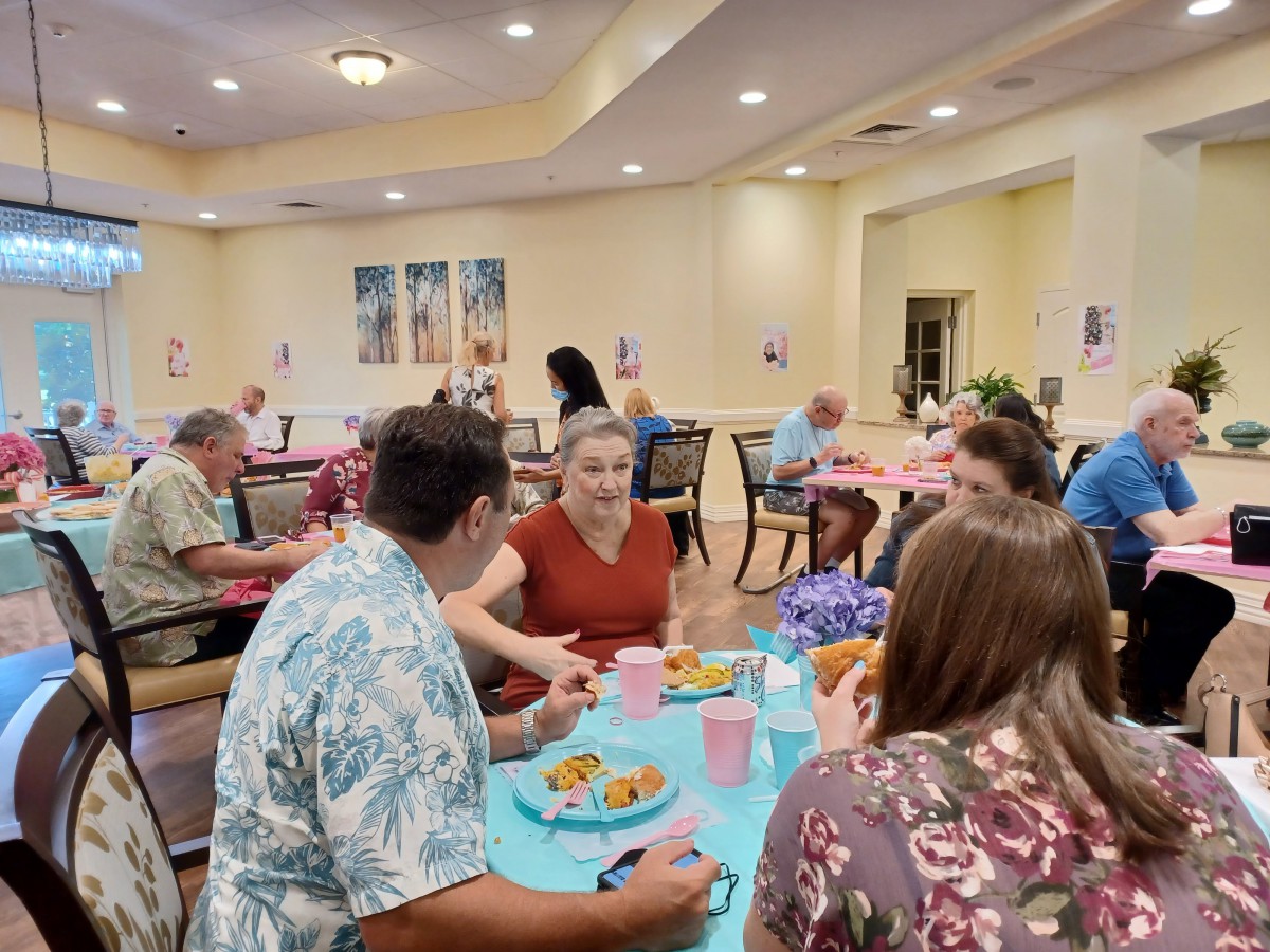 A group of people enjoying a meal together in an indoor dining area.