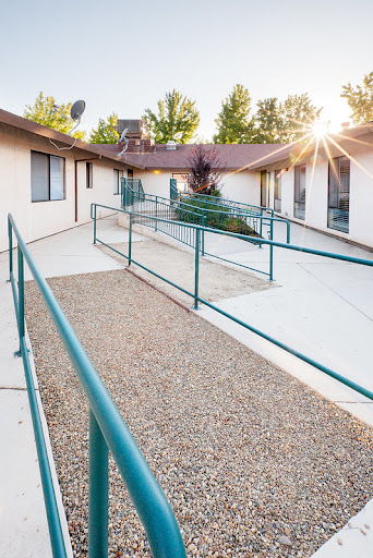An accessible pathway with ramps illuminated by sunlight.