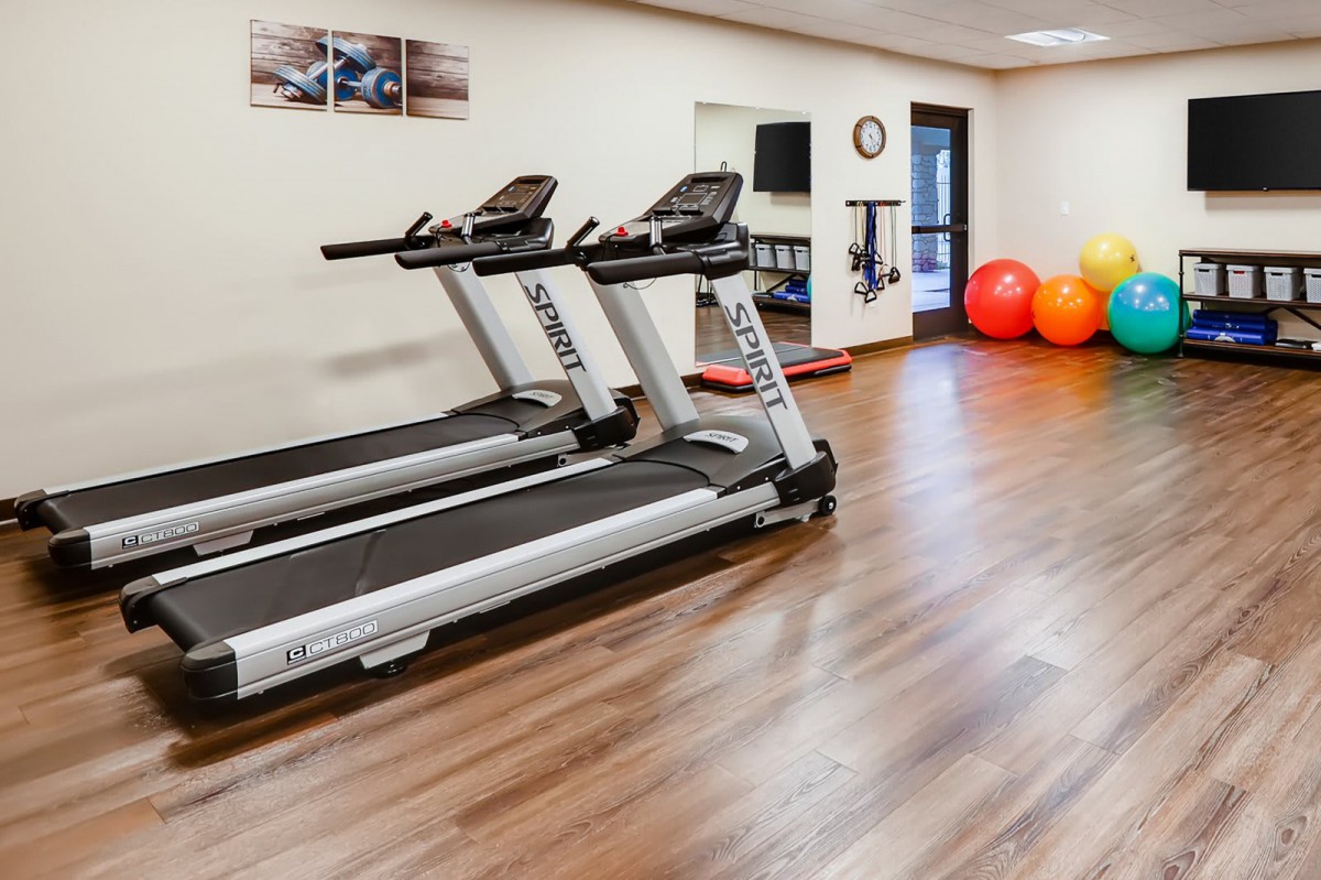 A modern gym with treadmills and fitness equipment.