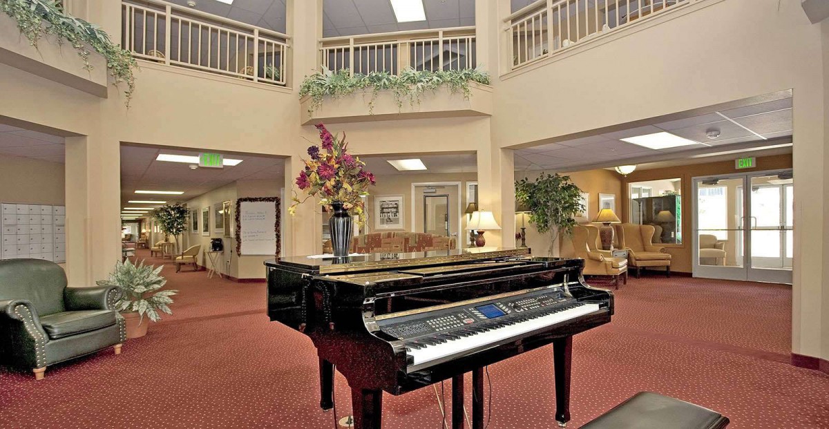 A grand piano in an elegantly decorated hotel lobby.