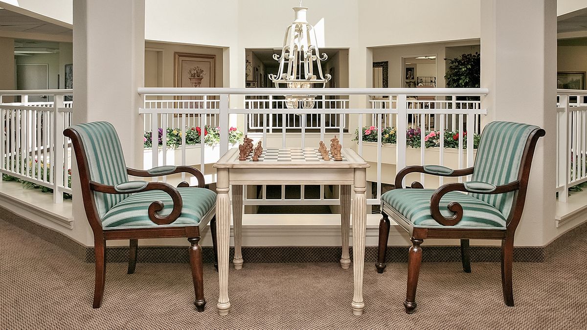 A traditional and elegant interior setting with a table and chairs.