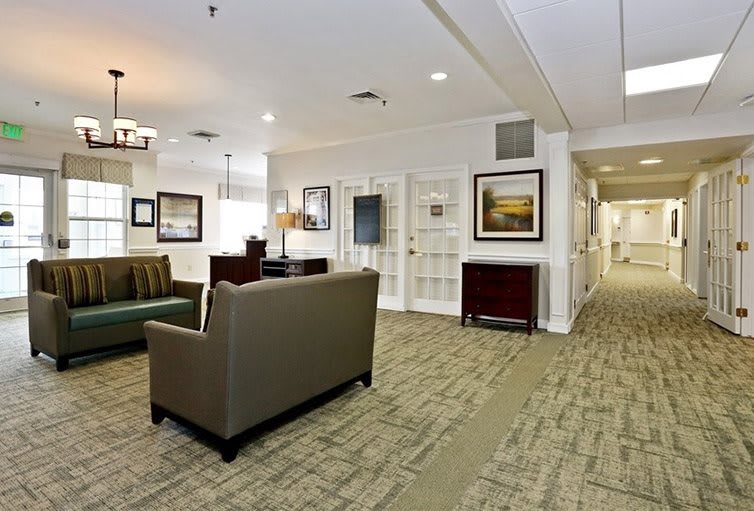 A well-furnished lobby area with comfortable seating and decorative artwork.