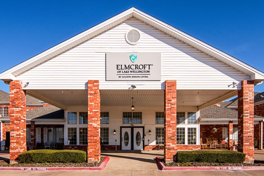 A healthcare facility building entrance with a sign reading 'Elm Croft'.