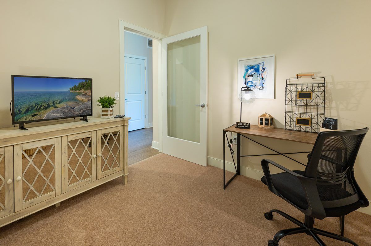 A cozy home office space with a desk, chair, and computer monitor.