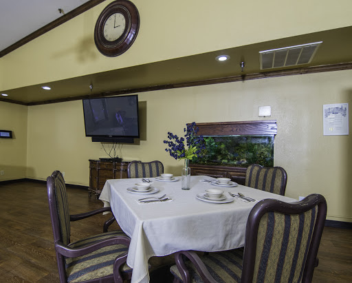 A cozy dining room featuring a neatly arranged table, comfortable chairs, and modern amenities.