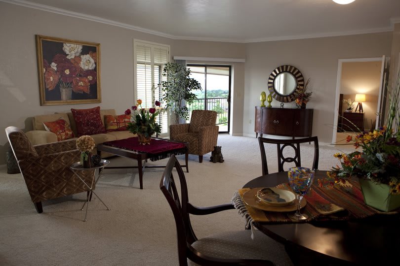 A cozy living room with a dining area, featuring elegant furniture and decor.