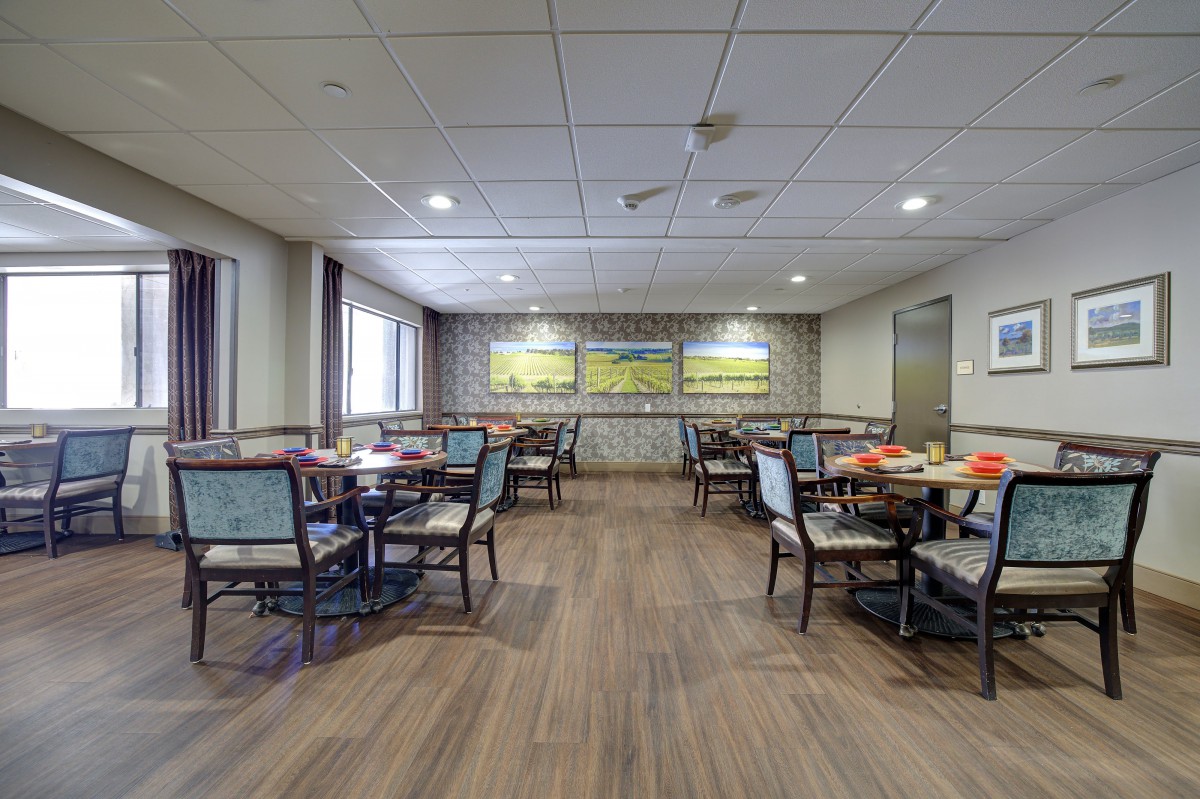 An empty dining area with several tables and chairs arranged neatly.