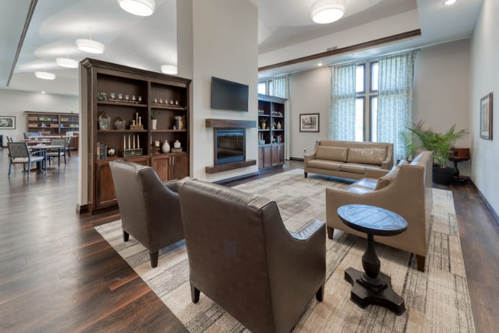 A modern living room featuring a fireplace and comfortable seating area.