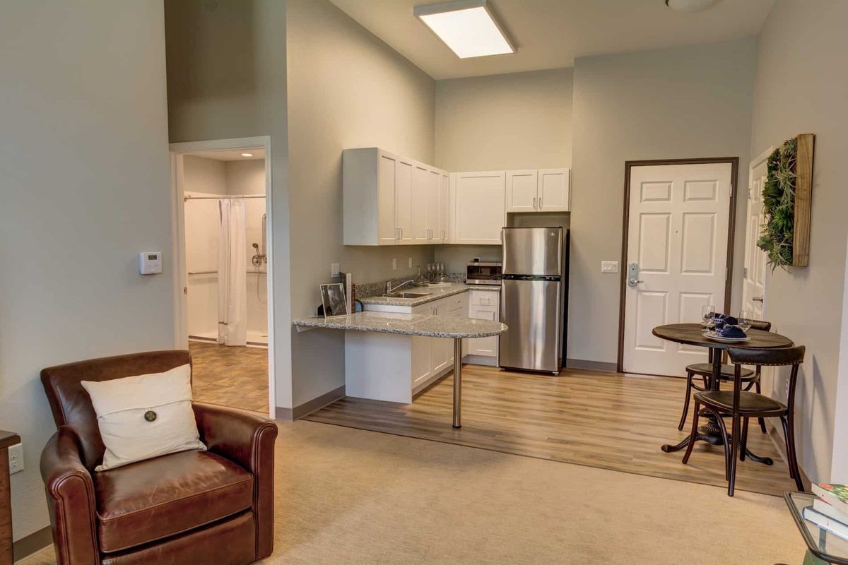 A modern open-concept kitchen and living area with stainless steel appliances and stylish decor.
