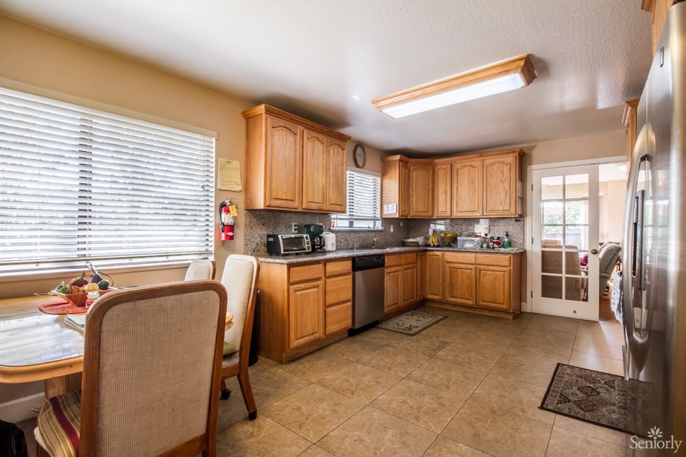 A clean and spacious kitchen with wooden cabinets and modern appliances.