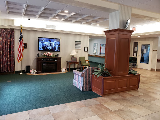 A welcoming lobby area featuring comfortable seating and a television, creating a cozy environment.