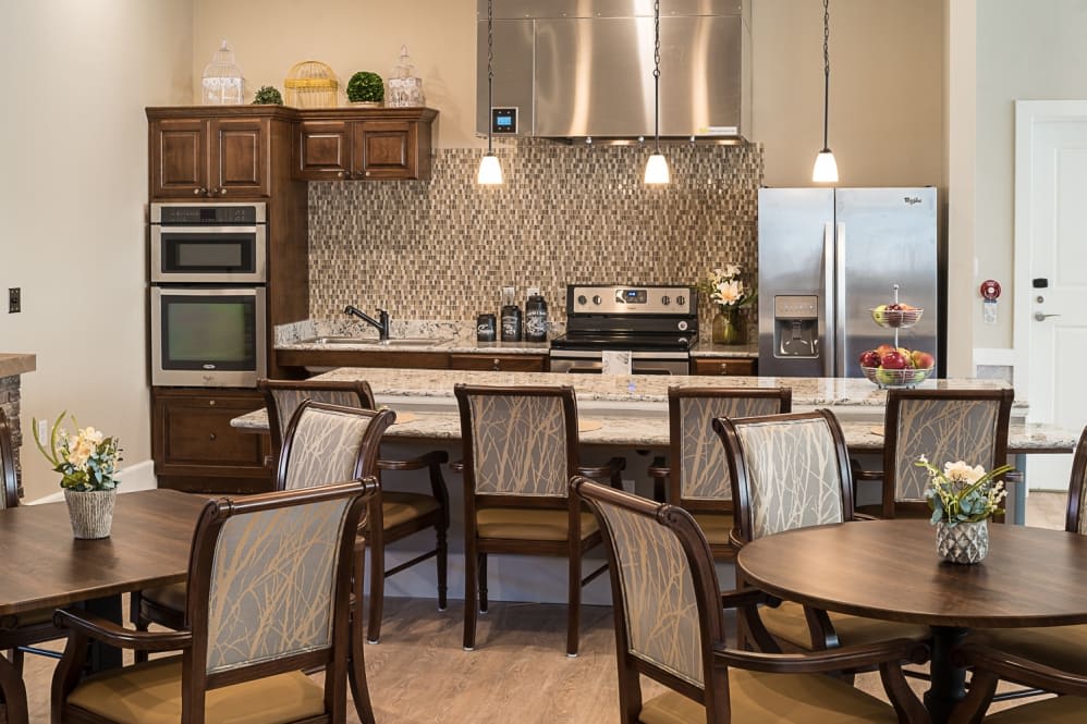 A modern kitchen with dining area featuring upscale appliances and elegant furnishings.