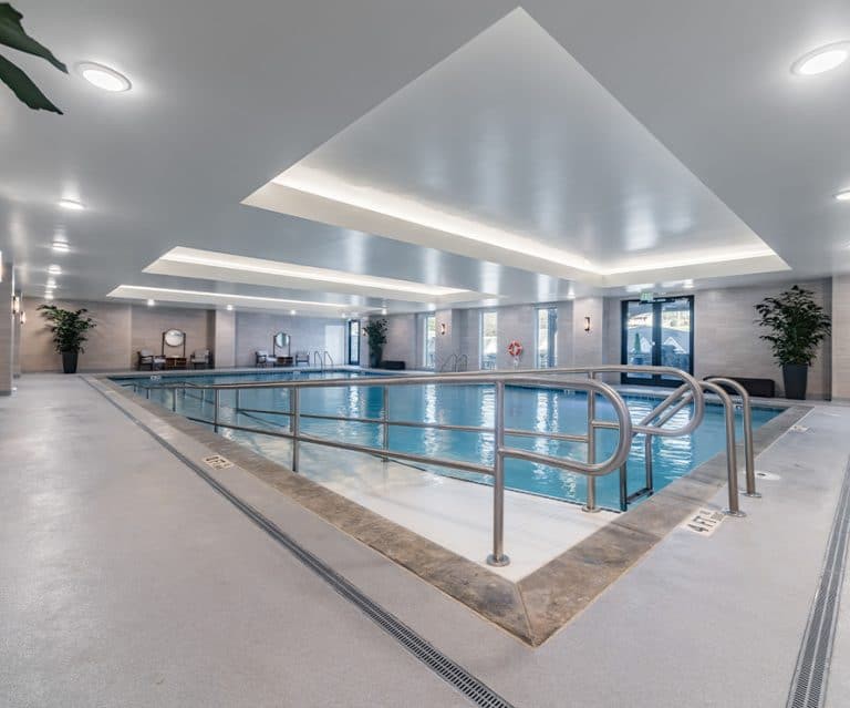 A modern indoor swimming pool with sleek architectural design.