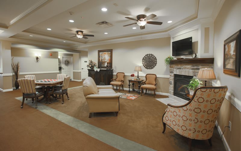 A cozy living room with comfortable seating, a fireplace, and a television.