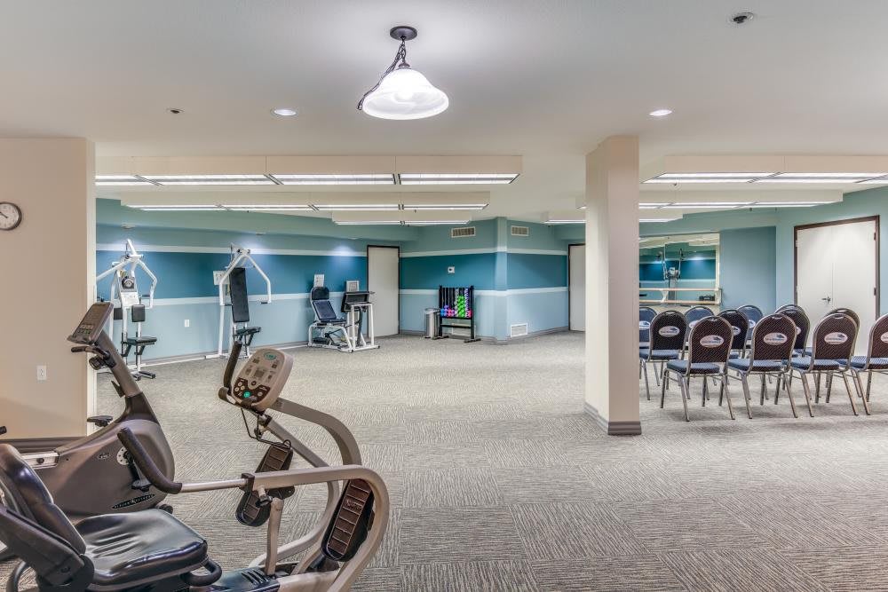 A spacious indoor gym featuring various exercise equipment including treadmills and stationary bikes.