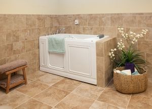 A bathroom featuring a walk-in bathtub with surrounding tiles and a towel hanging on the side.