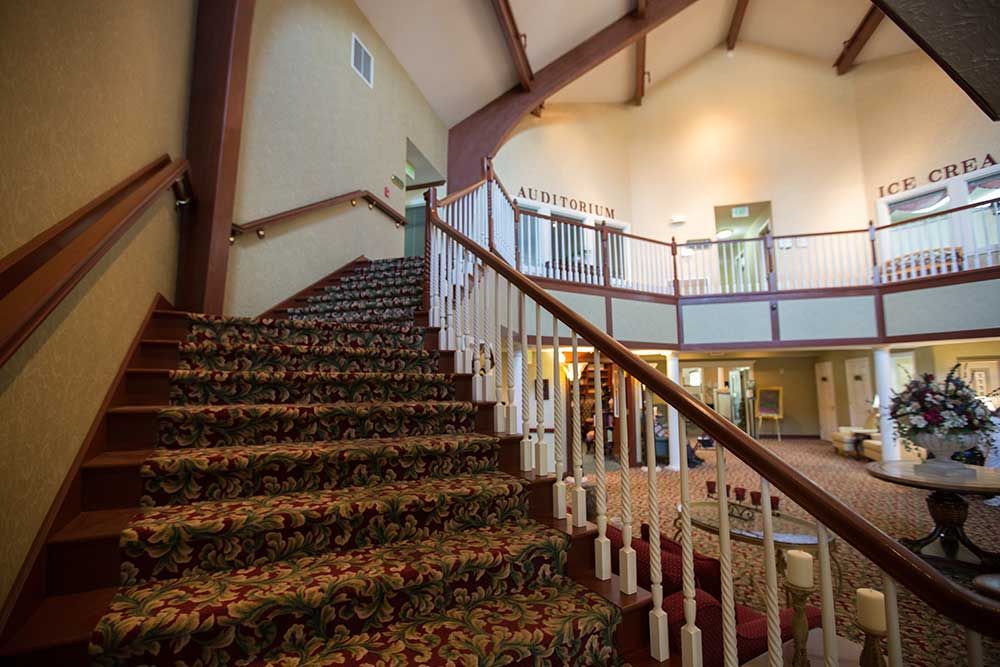 A view of an interior staircase with intricate carpet and railing design.