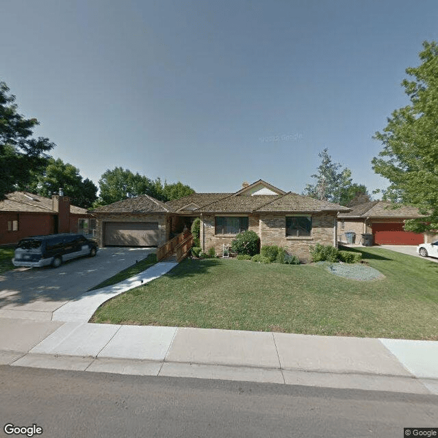 A suburban house with a driveway and neatly maintained front yard.