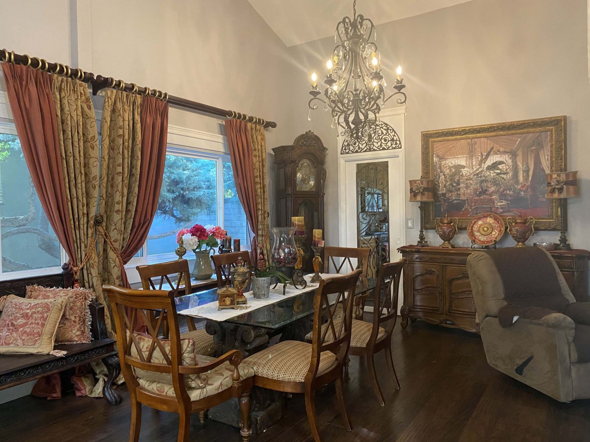 A cozy dining room with elegant decor and a chandelier.