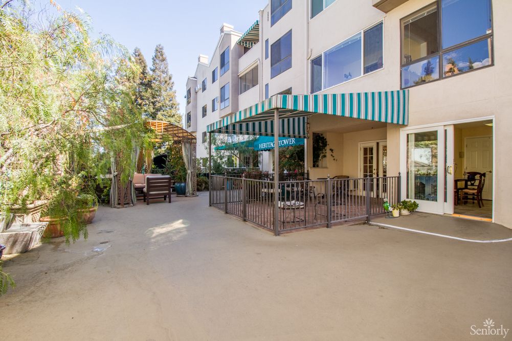 Outdoor view of a residential building with a patio and awning.