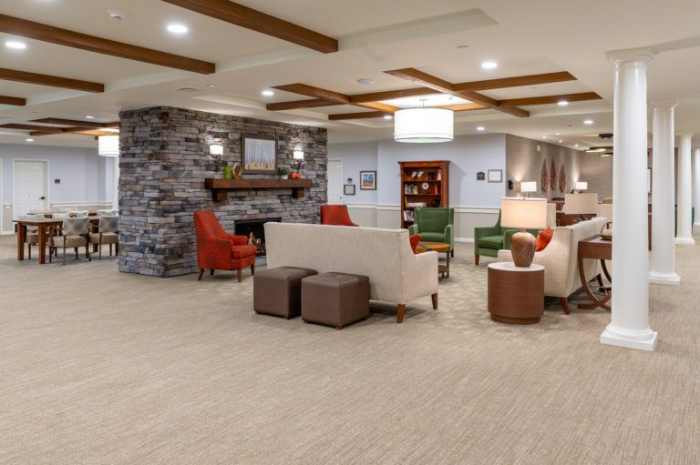 A modern lobby with comfortable seating and a cozy fireplace.